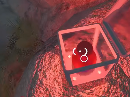 Opened glass box holding a red control-panel piece